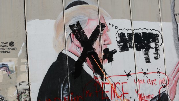 A defaced poster of the US President Donald Trump during a protest in Bethlehem, West Bank.