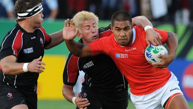 Sione Vaiomounga of Tonga, right, is tackled by DTH Van Der Merwe and Ryan Hamilton of Canada during the 2011 Rugby World Cup pool A match between Tonga and Canada in Whangarei, New Zealand.