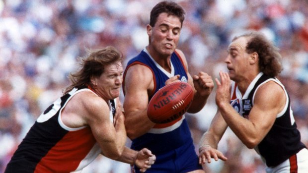 St Kilda's Michael Ford and Mick Dwyer contest ball with Footscray's Justin Charles in 1992.