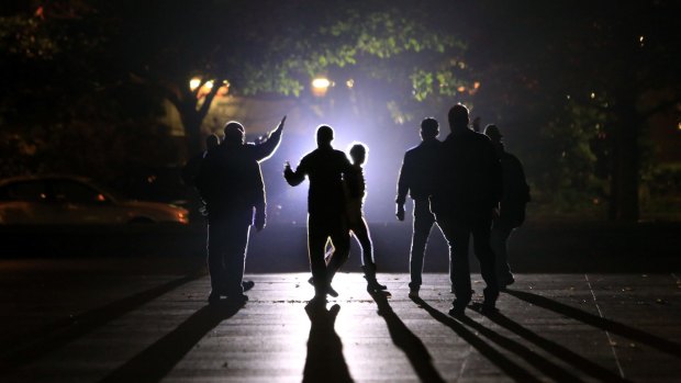 Residents are evacuated by the police in Saint-Denis, Paris, on Wednesday.