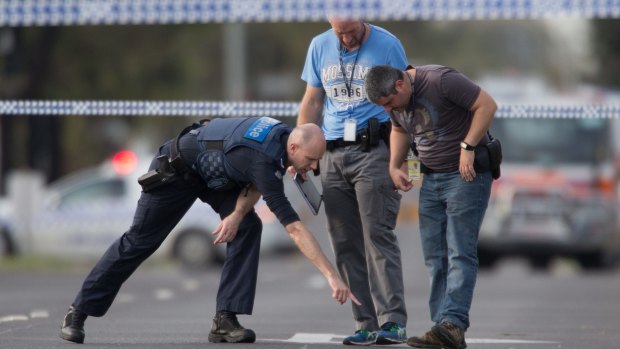 Detectives check the scene where a patrol car came under fire in Hoppers Crossing. 