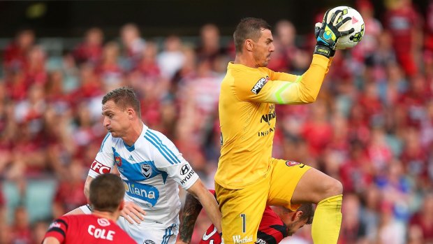Safe pair of hands: Ante Covic flies above the pack to secure the ball in Tuesday's 2-1 loss to Melbourne Victory.