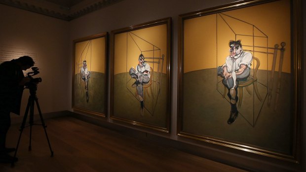 A cameraman films Francis Bacon's 'Three Studies of Lucien Freud' on display at Christie's on October 14, 2013 in London, England.