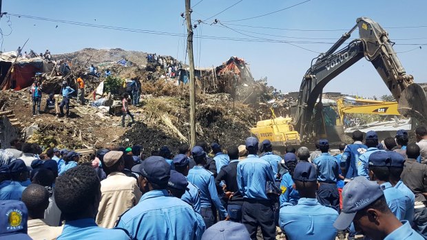 Police officers secure the perimeter at the scene of a rubbish landslide on the outskirts of Addis Ababa.