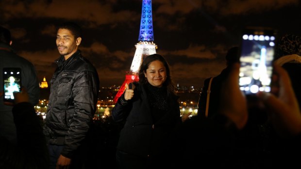 The Eiffel Tower lit up in the colours of the national flag for the second night in Paris on Tuesday. 