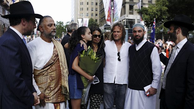 Tori Johnson's father, and sister (in blue) meeting religious leaders in Martin Place on Thursday.