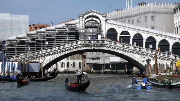 Scaffoldings are seen during the restoration of the Rialto Bridge on the Grand Canal in Venice lagoon.