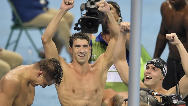 Michael Phelps, centre, celebrates his 19th Olympic gold medal.