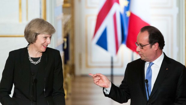 Theresa May smiles as Francois Hollande speaks during a news conference at Elysee Palace in Paris, France, on Thursday.