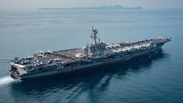 In this Saturday, April 15, 2017 photo released by the U.S. Navy, the aircraft carrier USS Carl Vinson transits the Sunda Strait between the Indonesian islands of Java and Sumatra.