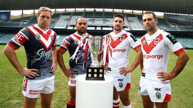 Traditional clash: Sydney Roosters players Mitch Aubusson and Sam Moa with St George Illawarra Dragons opponents Gareth Widdop and Jason Nightingale with the ANZAC Day trophy.