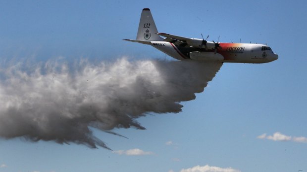 The large air tanker C-130 Hercules "Thor" does a water drop fly-by as fire authorities gear up for an early and active fire season.