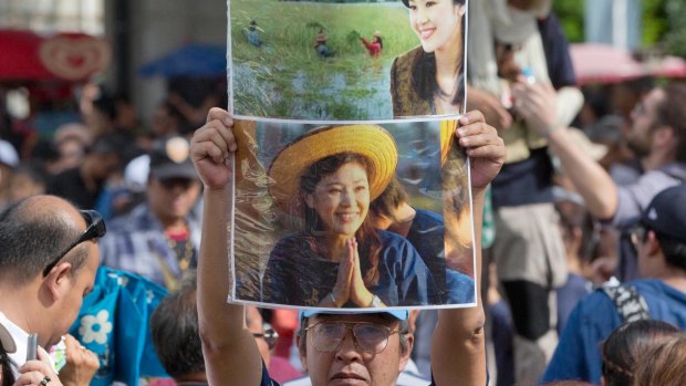 Supporters of Thailand's former Prime Minister Yingluck Shinawatra display her images outside the Supreme Court after Yingluck failed to show up to hear a verdict in Bangkok, Thailand.