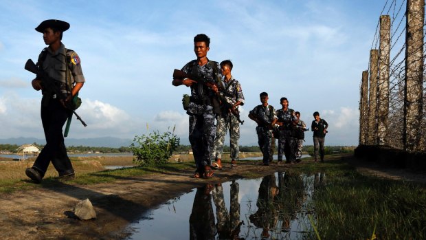 Myanmar police officers patrol along the border fence between Myanmar and Bangladesh in Maungdaw, Rakhine State, Myanmar. 