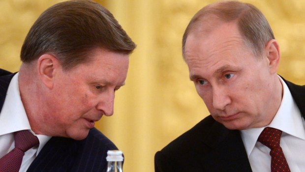Russian President Vladimir Putin, right, listens to his now-demoted chief of staff Sergei Ivanov during a meeting in the Kremlin in Moscow, Russia. 