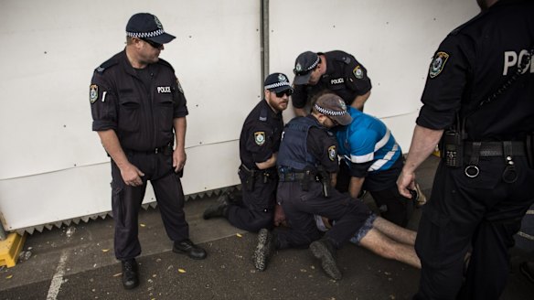 Police attend to a festivalgoer at Sydney Olympic Park.