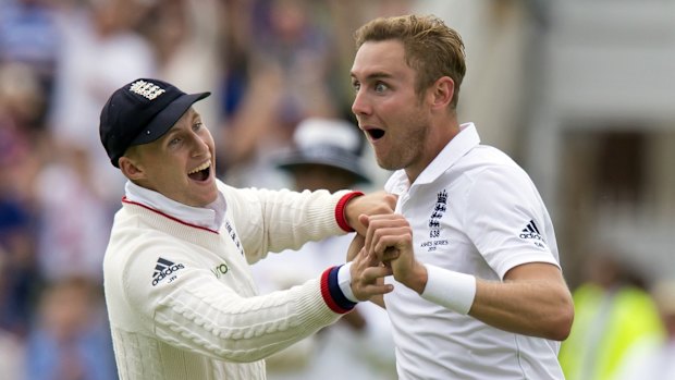 England's Stuart Broad, right, celebrates with teammate Joe Root.