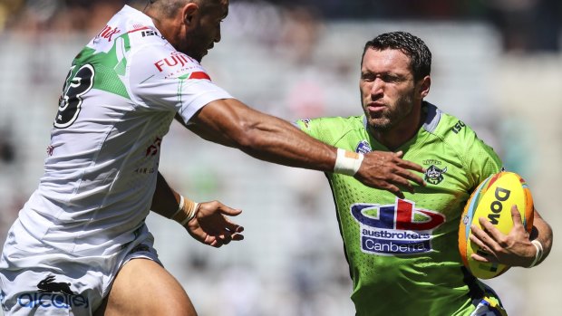 Canberra's Zachary Santo fends off a Rabbitohs defender in their Auckland Nines clash at Eden Park.