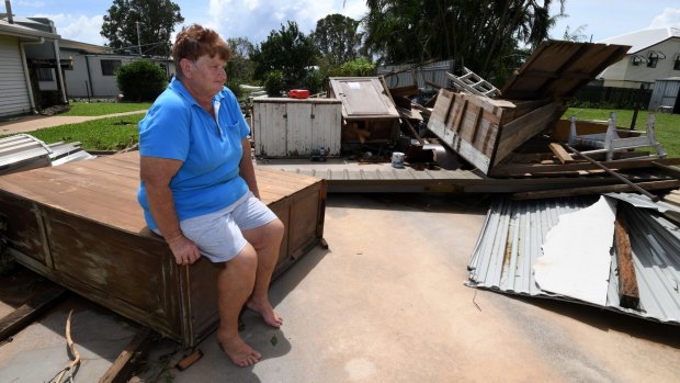 Helen Muller sits in the ruins of her double garage.