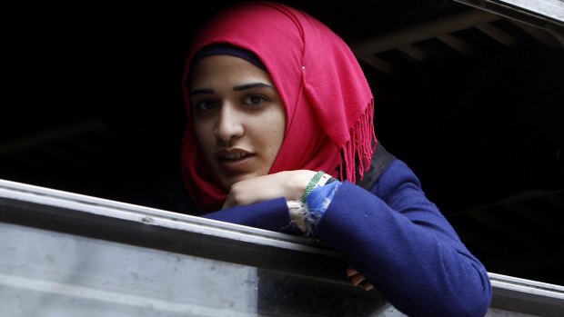 A refugee looks out from a window of a train at the transit centre for refugees in Macedonia.