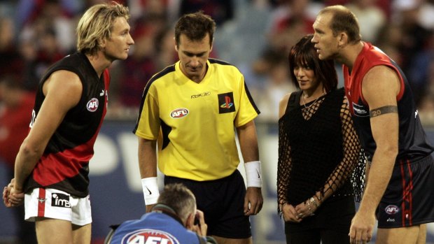 AFL football at MCG. Round 1 Melbourne Vs Essendon.  Trisha Broadbridge tossed the coin and David Neitz and James Hird choose their directions  FAIRFAX Picture by JOHN FRENCH The Age 26th March 2005.  jaf050326.001.004 SPECIAL MELBVESS