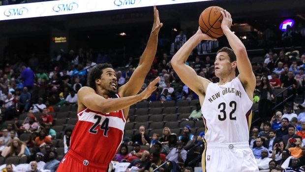 Defending his position: Washington veteran Andre Miller tries to stop Pelicans shooter Jimmer Fredette getting his shot away.