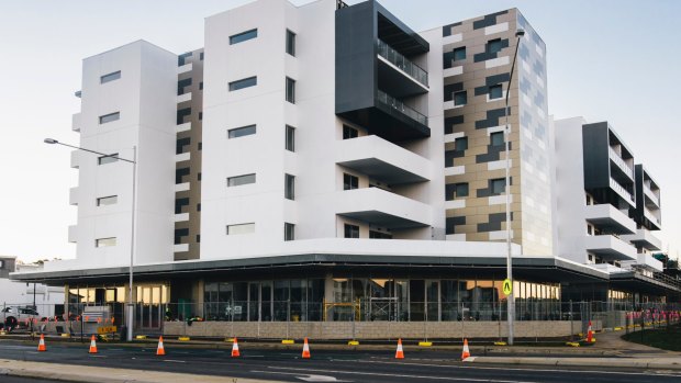 The Esque building on the corner of Flemington Road and Manning Clark Crescent in Franklin: The developers has offered to pay for electricity meters for apartment owners who can't get their chosen colour scheme.
