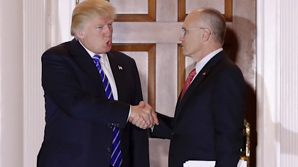 Donald Trump and Andrew Puzder, chief executive of CKE Restaurants, shake hands in a photo taken in November.