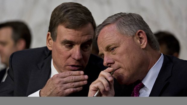 Senator Richard Burr, a Republican from North Carolina and chairman of the Senate Intelligence Committee, right, and ranking member Senator Mark Warner, a Democrat from Virginia, talk during the hearing.