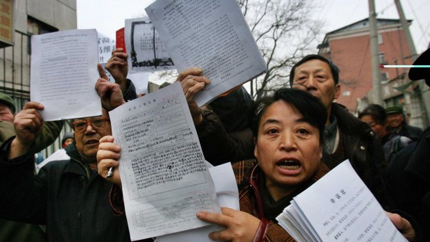 Chinese voice their grievances outside of a supreme court petitions office in Beijing.