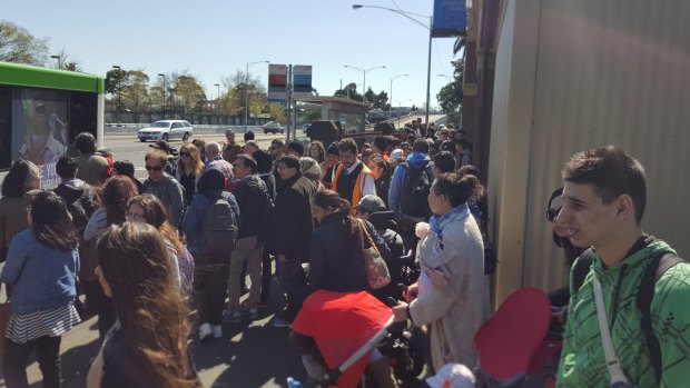 Commuters wait for replacement buses at Clifton Hill station.