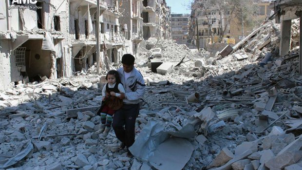 A man and girl amid the rubble of houses destroyed in 2014 by Syrian government air strikes in the city of Aleppo. Every blow to Islamic State in Syria strengthens the Assad regime.