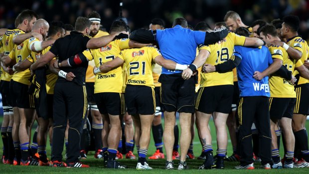 Sad night: Hurricanes players observe a minute's silence for Jerry Collins in Napier.
