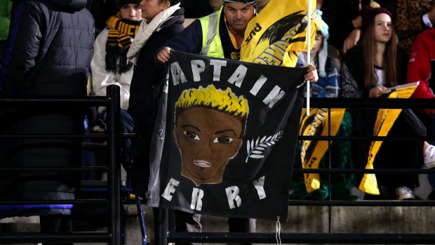 Not forgotten: A Hurricanes fan holds a banner in memory of Jerry Collins in Napier.