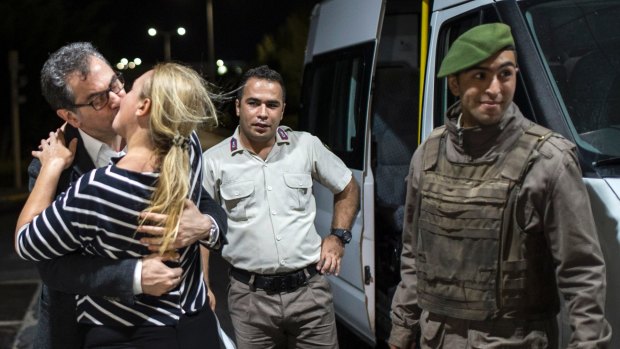 Kadri Gursel, a columnist for Turkey's main opposition newspaper Cumhuriyet, kisses his wife Nazire Kalkan Gursel after his release from Silivri prison outside Istanbul.