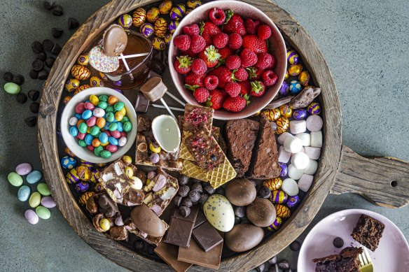 Fresh berries, chocolate-dipped wafers and portions of chocolate cake and rocky road add visual interest to this chocolate grazing platter.