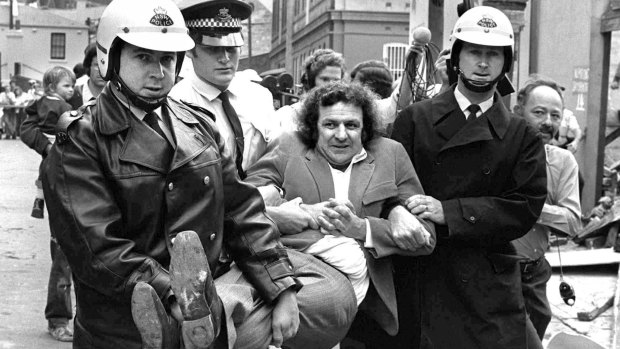 Former BLF boss and green ban man Jack Mundey being carried from a protest at The Rocks in the early seventies.
