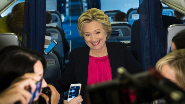 Hillary Clinton appeared upbeat speaking with the media on board her campaign plane on Tuesday. 