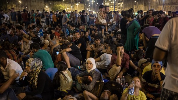 Migrants gather in front of Keleti station in central Budapest.