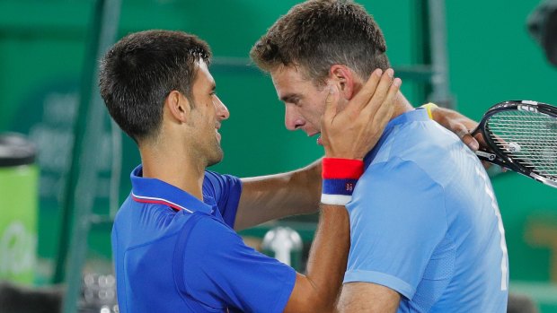 Juan Martin del Potro cries while hugging Novak Djokovic.