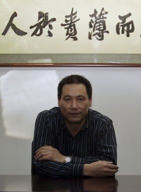 Chinese lawyer Pu Zhiqiang, whose trial is throwing harsh light on the government's attitude to dissent. Above his head is a saying of Confucius: "He who puts more blame on himself and less on others for any faults can keep hatred and grievances away."