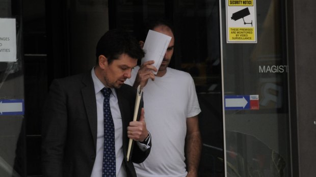 Peter Poulakis, right,  leaves court with his lawyer after he was granted bail.