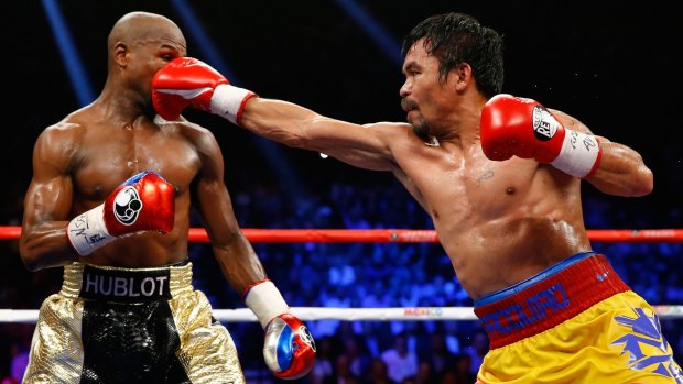 Manny Pacquiao throws a right at Floyd Mayweather during their welterweight unification championship bout in May 2015.