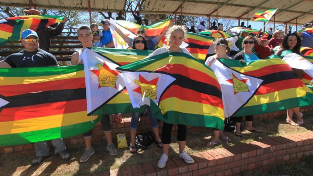People display flags during the test cricket match between New Zealand and Zimbabwe in Zimbabwe in August.