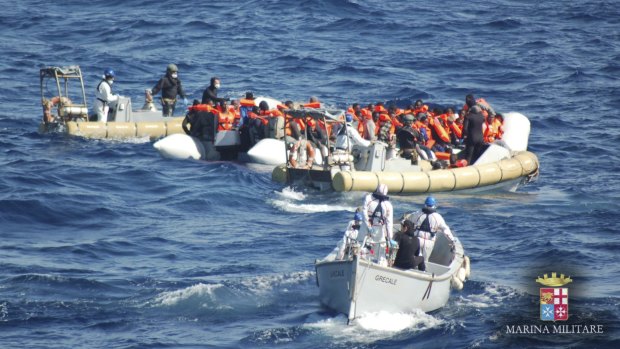 Migrants on a dinghy boat are rescued by Italian Navy's personnel off the coast of Lampedusa island, Italy. 