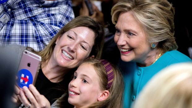 Feeling emboldened: Hillary Clinton gets a selfie with supporters.