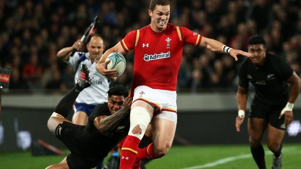 Going nowhere: George North is tackled by Malakai Fekitoa of the All Blacks.