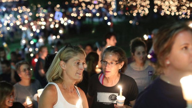 People participate in a candlelight vigil at the University of Virginia on Wednesday night