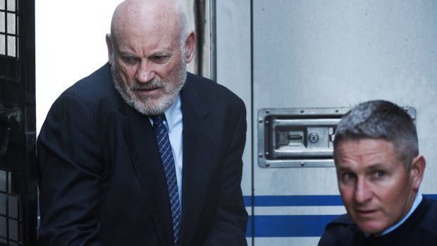Ian Macdonald is led into the Supreme Court on Friday to be sentenced. 