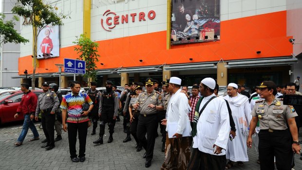 The Islam Defenders Front delegation speak to police outside a Surabaya shopping centre.